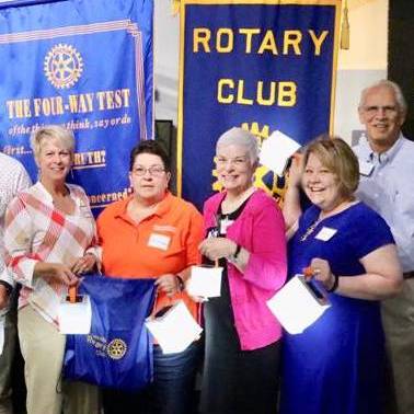 Rotary club members holding their lights.